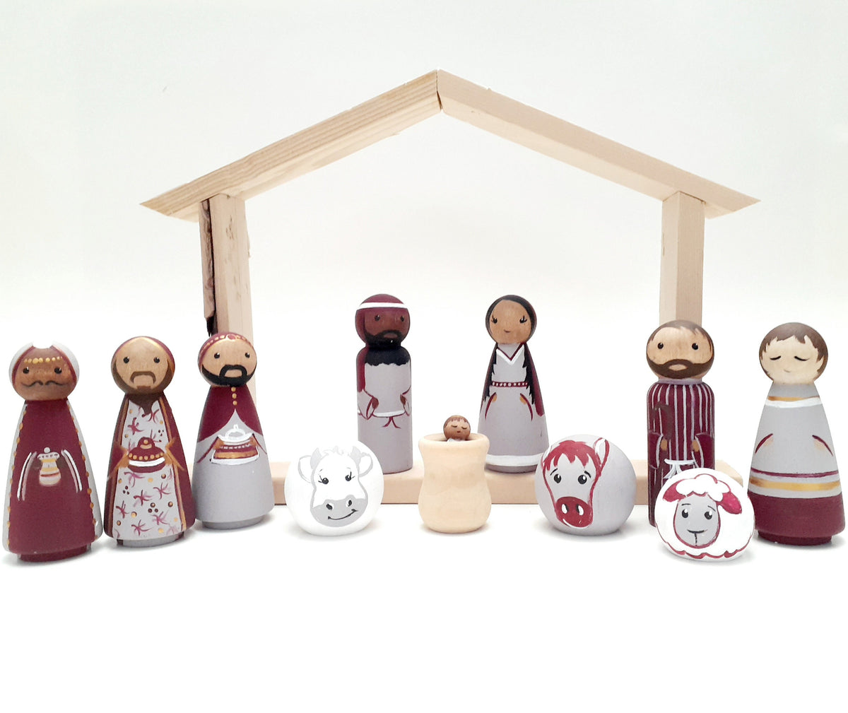 wooden peg doll nativity set in marroon, light purple and gold colors. 13 pieces